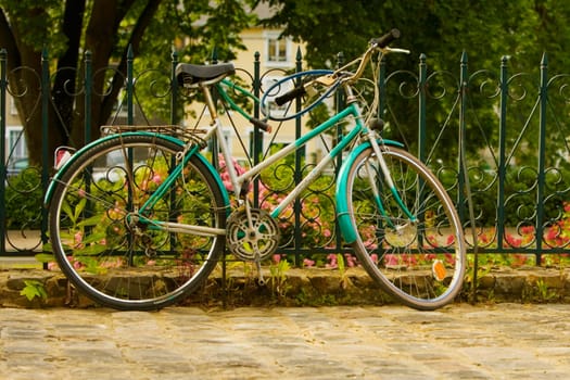 Close-up of a bicycle locked against a railing