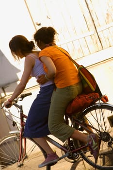 Side profile of two women cycling