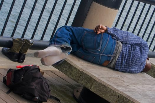 Rear view of a man lying on a bench