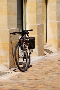 Bicycle parked against a wall
