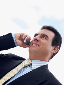 Close-up of a businessman talking on a mobile phone and smiling