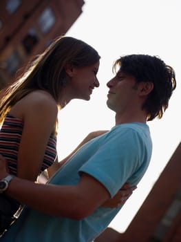Side profile of a young couple embracing each other