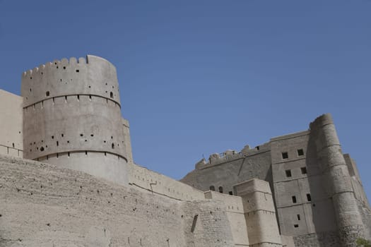 The great fortress Hisn Tamah,built in the 17th century in the oasis city of Bahla,is located at the foot of the Jabal al Achdar Mountains. It was built from traditional building materials.