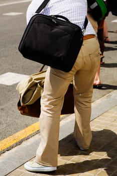 Rear view of a man carrying bags