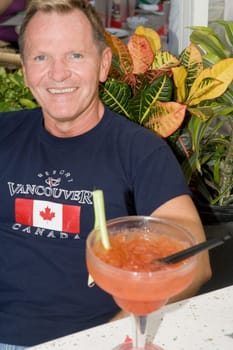 Portrait of a mature man smiling and sitting in a restaurant