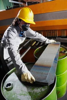 Mid adult man wearing a hardhat and working in a factory