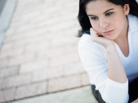High angle view of a young woman looking away and thinking