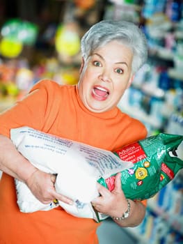 Portrait of a senior woman holding packets