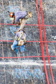 High angle view of two construction workers working at a construction site