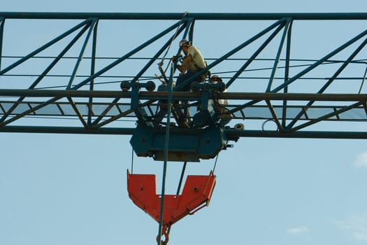 Low angle view of three construction workers working at a construction site