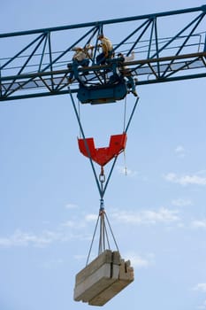 Low angle view of three construction workers working at a construction site