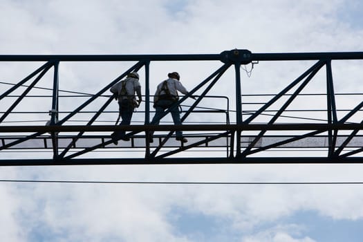 Low angle view of two construction workers working at a construction site