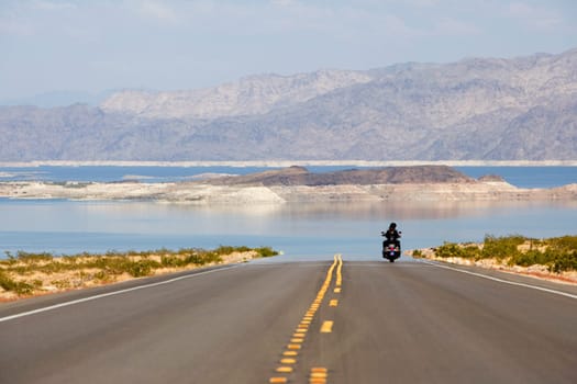 Rear view of two people on a motorcycle near the sea, Las Vegas, Nevada, USA