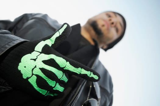 Low angle view of a young man wearing a glove
