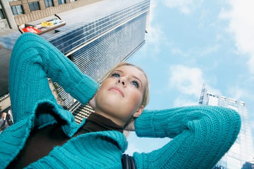 Low angle view of a teenage girl with her hands behind her head