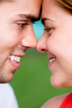 Close-up of a young couple looking at each other and smiling