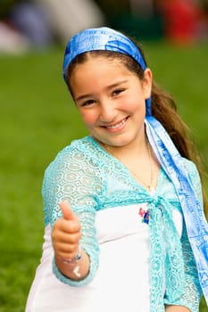 Portrait of a girl showing a thumbs up sign