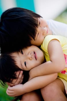 Close-up of a girl leaning over her sister