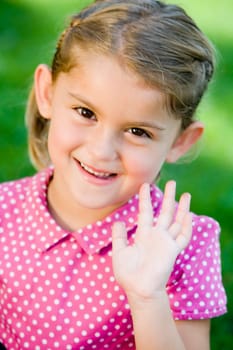 Portrait of a girl waving her hand