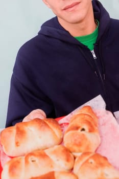 Close-up of a person holding buns in a tray