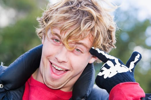 Portrait of a young man smiling with his finger on his head
