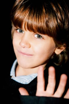 Portrait of a boy showing a stop gesture