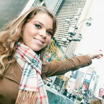 Portrait of a teenage girl smiling and pointing