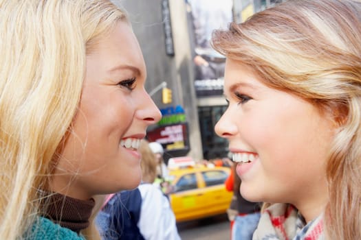 Close-up of two teenage girls smiling
