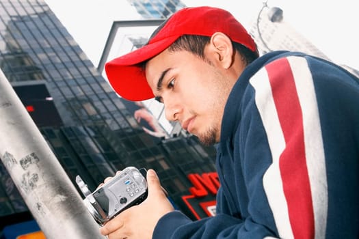 Close-up of a young man operating a home video camera