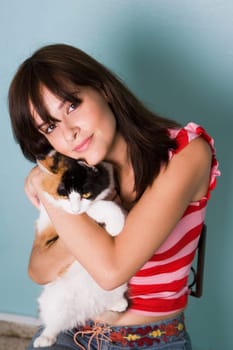 Portrait of young woman with cat