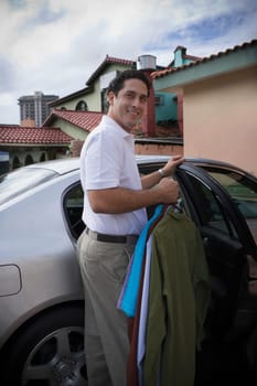Man taking clothes out of car