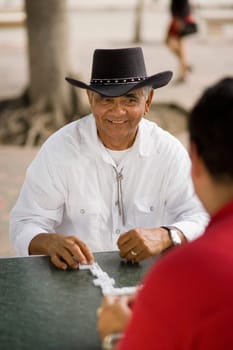 Men playing dominos, outdoors