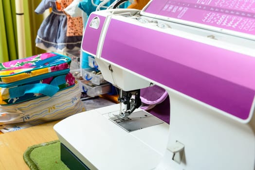purple sewing machine in the workshop of a seamstress