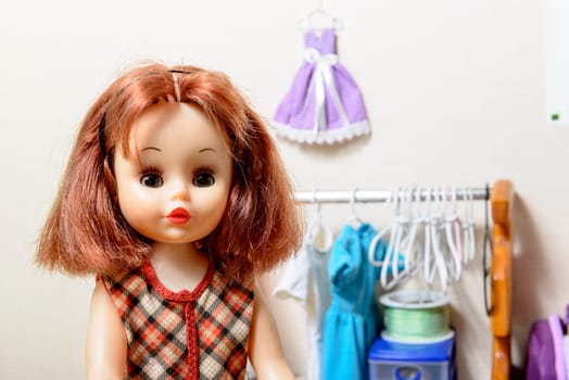 doll with red hair and  several  dress