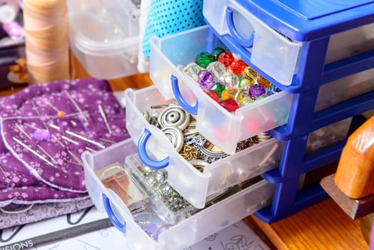 box filled with various buttons in the workshop of a dressmaker