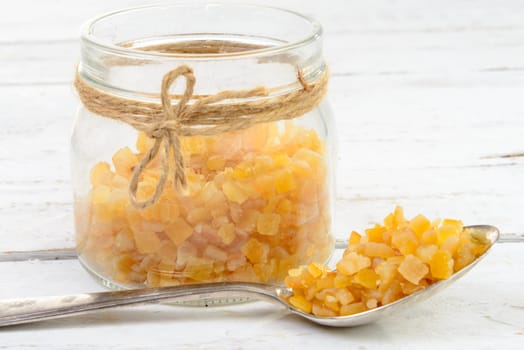 candied oranges cut into pieces on the white wooden table