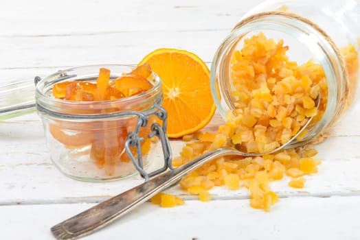 candied oranges cut into pieces on the white wooden table