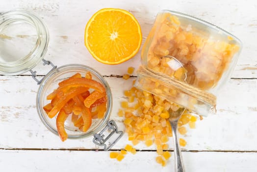 candied oranges cut into pieces on the white wooden table
