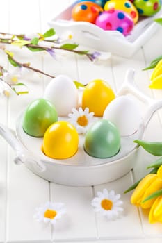 Easter eggs with spring flowers decorating table