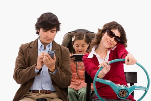 Studio portrait of distracted family in imaginary car