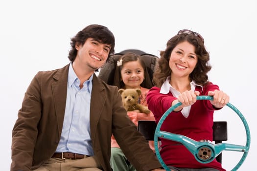 Studio portrait of happy family in imaginary car