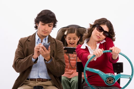 Studio portrait of distracted family in imaginary car