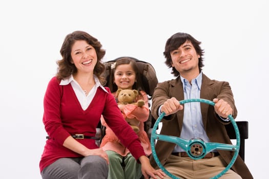 Studio portrait of happy family in imaginary car