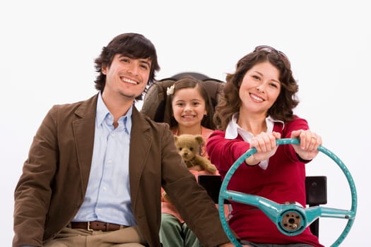 Studio portrait of happy family in imaginary car