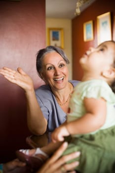 Mature woman looking at her granddaughter and smiling