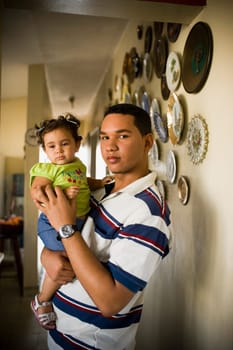 Portrait of a young man carrying his sister