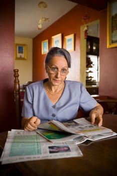 Portrait of a mature woman holding a newspaper