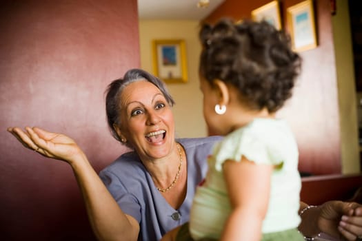 Mature woman looking at her granddaughter and smiling