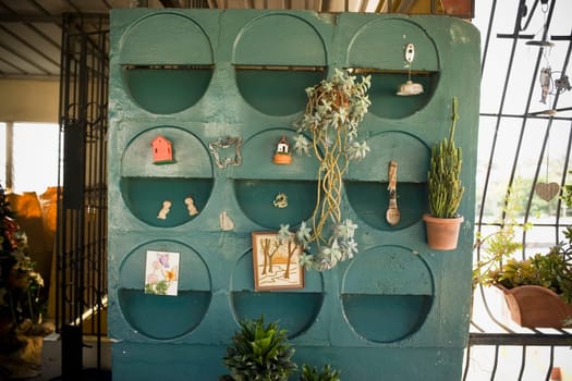 Potted plants and paintings hanging on a wall
