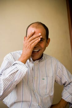 Portrait of a mature man smiling with his hand on his face